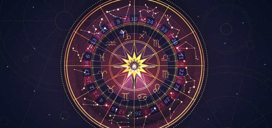 An astrological chart laid over a roulette wheel.