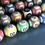 Multicolored bingo balls with numbers on.