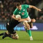 Garry Ringrose of Ireland is tackled by Brodie Retallick of the All Blacks during in an International test match at Eden Park