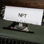 A typewriter with NFT written on paper.