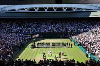 Novak Djokovic and Nick Kyrgios hold their trophies after the Men's Singles Final at Wimbledon.