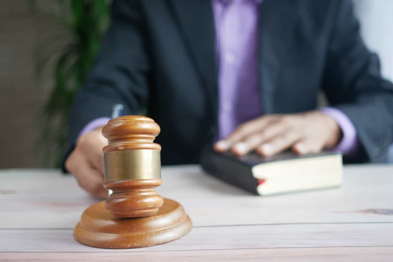 A judge with a gavel and book. 