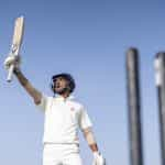 Cricket player holding up his bat