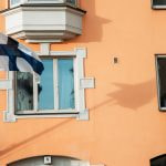 An unfurled flag in the wind against a blue sky.