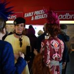 Smartly dressed women outside Ladbrokes betting shop in Punchestown Racecourse.